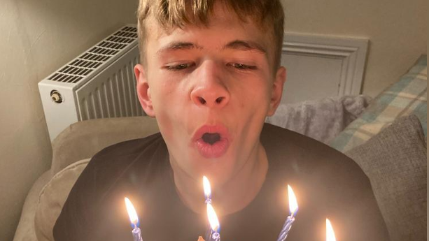 Mikey Roynon blowing out candles on a birthday cake