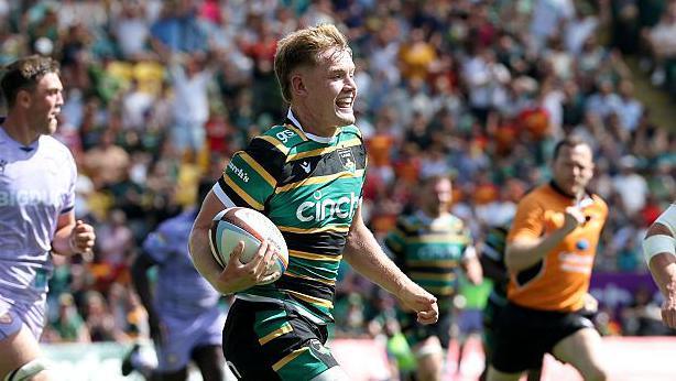 Fin Smith races away to score a try for Northampton Saints against Gloucester