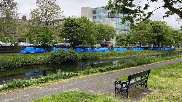 Tents pitched alongside the canal