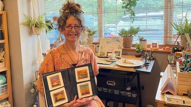 Caroline the tea bag artist with some of her miniature artwork in a folder