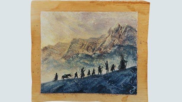 Gandalf and the hobbits trekking up a mountain painted on a teabag.