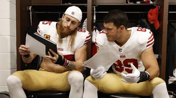 George Kittle talks with Charlie Woerner in the San Francisco 49ers locker room