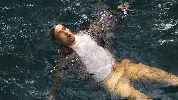 RNLI image of man in floating on his back in water. He is breathing with an open mouth with his ears submerged and limbs spread out to stay afloat