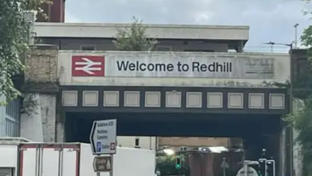 A sign on a railway bridge by Redhill station saying 'Welcome to Redhill'