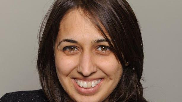 Anita Nayyar smiling at the camera with dark hair