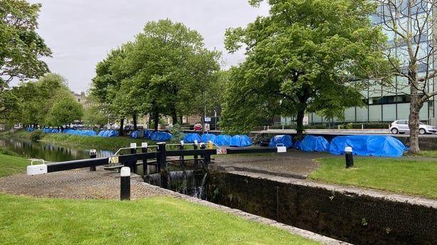 Tents pitched alongside the canal