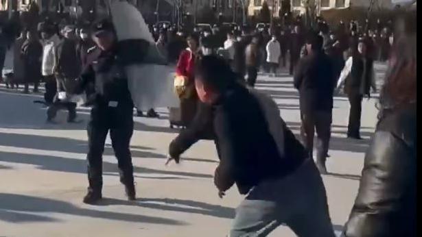 A protester hurling an object at a police officer in a Pucheng demonstration. Grab from video on X