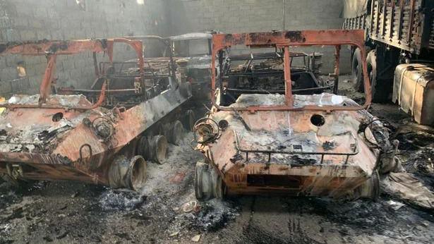 Close-up of burnt-out cars in a car park