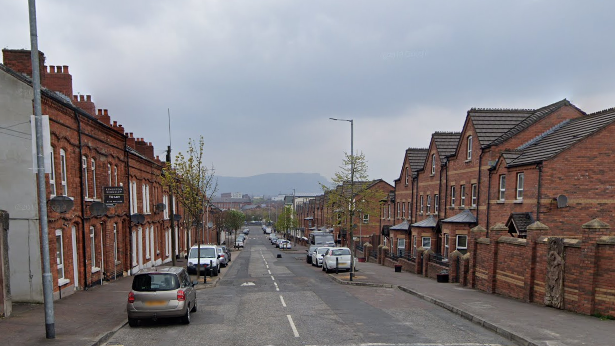 A row of houses and parked cars on a section of Roden Street, Belfast