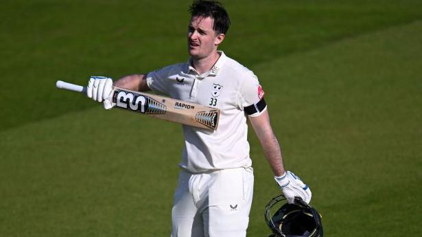 Gareth Roderick points to the number 33 worn by all the Worcestershire players in Josh Baker's memory