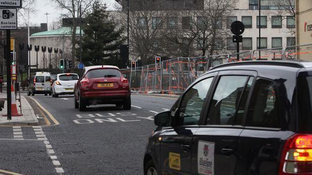 An image of cars travelling in a bus lane