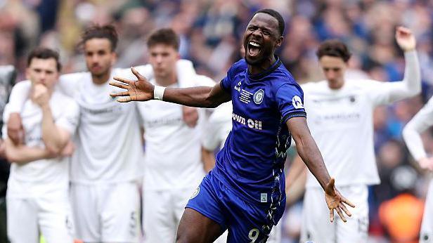 Mani Dieseruvwe of Rochdale celebrates victory after a penalty shootout