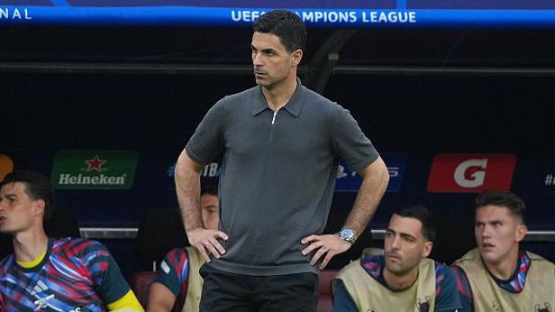 Mikel Arteta with his hands on his hips on the touchline