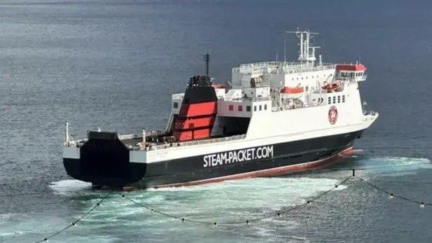 The Ben-my-Chree, sailing out of Douglas Bay. It is black, white and red with Steam-Packet.com written on the side along with the firm's logo.