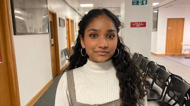 Imansa standing in a corridor at Oxford Crown Court