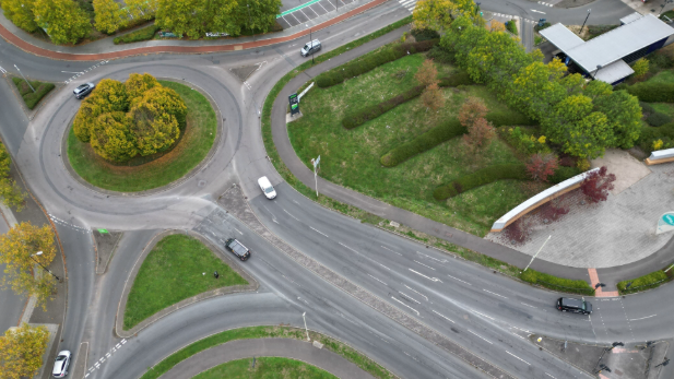 Aerial image of several roads meeting at a large roundabout.