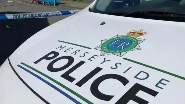 The bonnet of a Merseyside Police car, with has the force's name printed on.