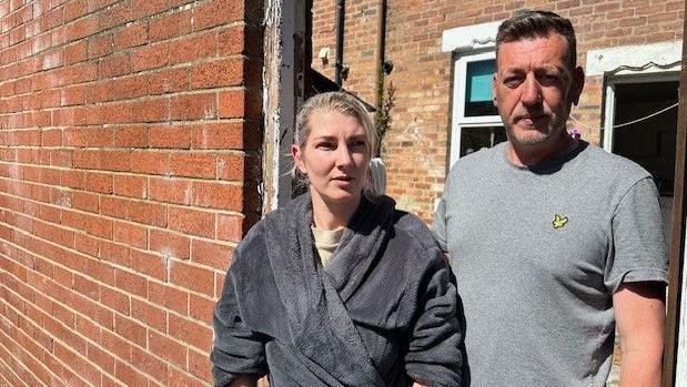 Hannah Wright (left) and Andrew Green (right) standing next to each other outside their Willington home