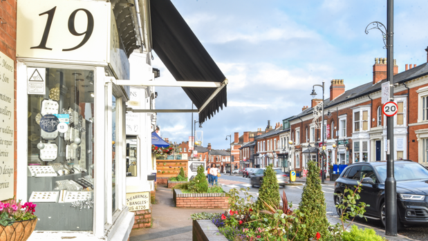 A pretty road in The Jewellery Quarter, Birmingham, with jewellers lining one side of the road and houses on the other.