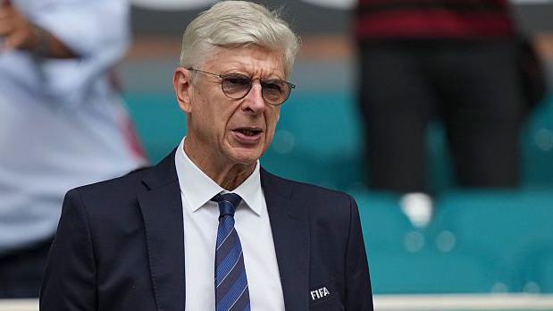 Arsene Wenger wearing a Fifa blazer