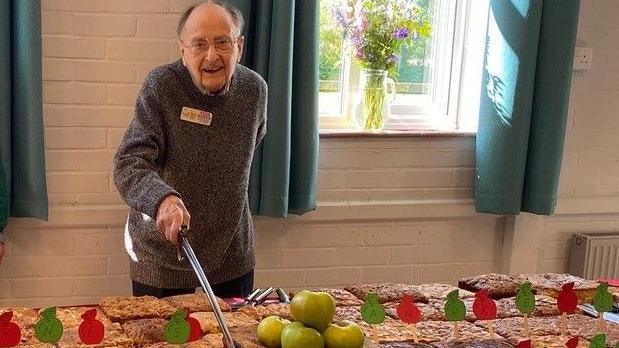 Jeff Blake cutting the cake with a sword