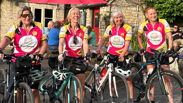 The ‘Chalford Mums’, Karen (L), Julia, Kate, and Christine standing outside a pub with their bikes for a picture