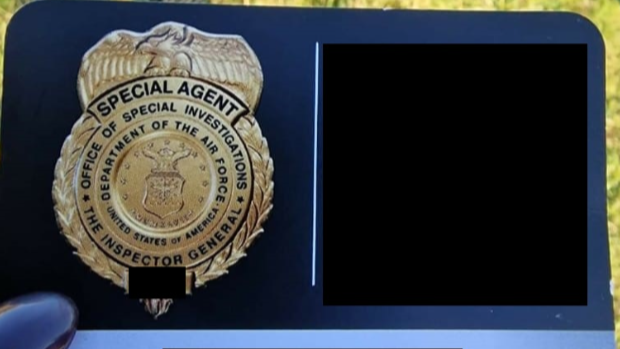 Image shows business card of a USAF special investigator. On the left is a badge with the words: "Special Agent. Office of Special Investigations. Department of the Air Force, United States of America." On the right is a black square where contact information has been redacted.