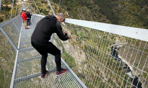 towns-people-walking-across-the-worlds-longest-pedestrian-bridge