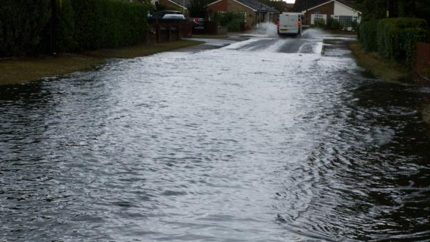 Flooding in a street in Watton with a van just leaving the water