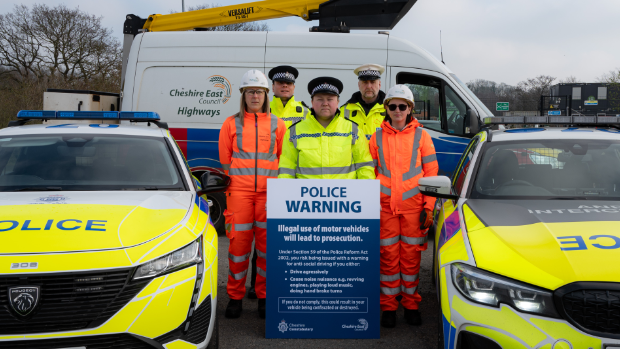 Police vehicles and a warning sign