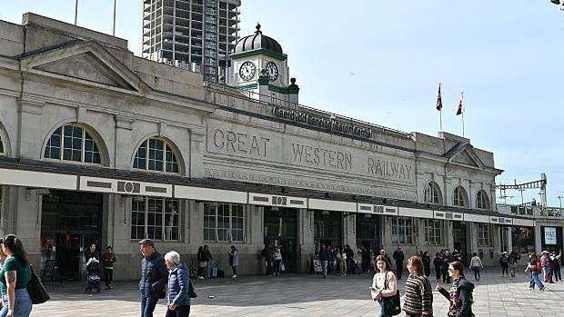 People walking in front of Cardiff Central rail station