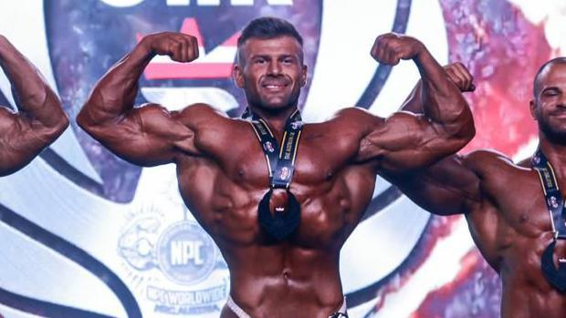 Joey Farrell celebrates after winning a bodybuilding competition