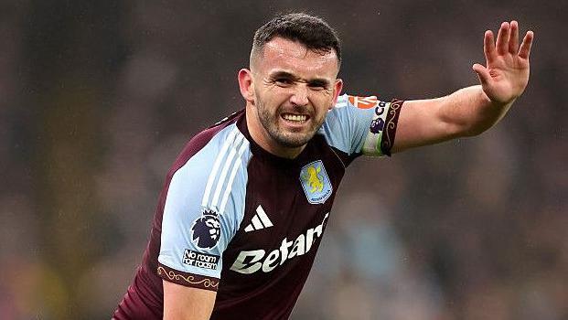 John McGinn signals he is injured during an Aston Villa match