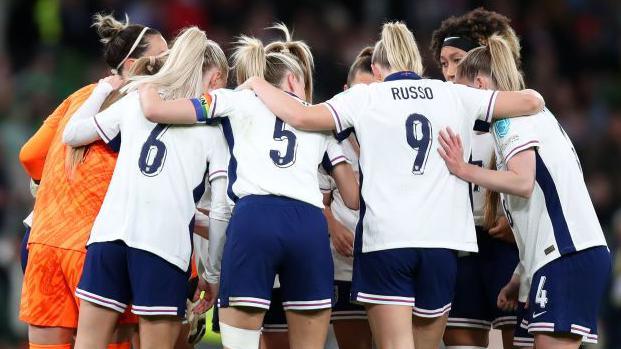 England players form a huddle before their Women's Euro 2025 qualifier away to the Republic of Ireland in April 2024