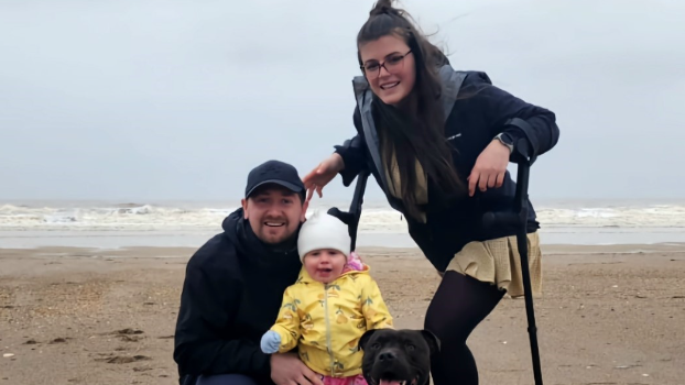 Bethany on the beach with her daughter and partner 