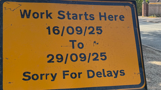 A yellow sign warning motorists of a road closure in Westerfield Road between the 16 September and 29 September. It reads 'Sorry For Delays'