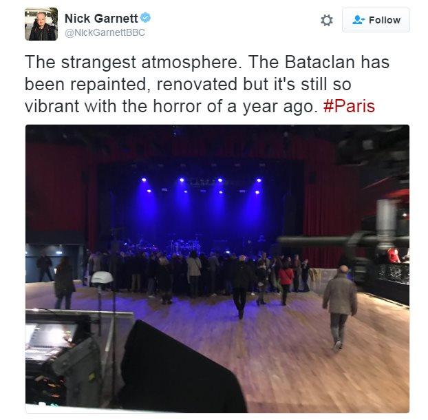 A tweet from BBC Five Live's Nick Garnett, sharing a picture of the concert hall which he says it still "vibrant with the horror of a year ago"