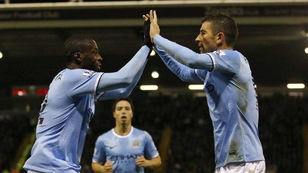 Yaya Toure celebrates his goal for Manchester City with Aleksandar Kolarov