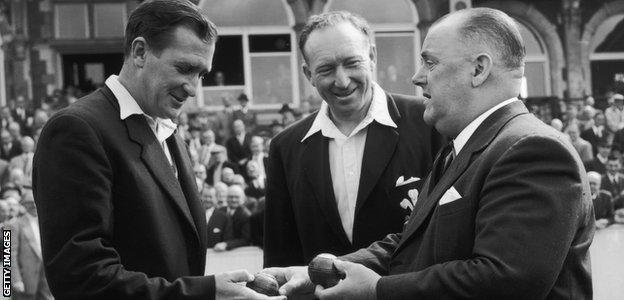 Jim Laker is presented with the balls he used to take 19 wickets