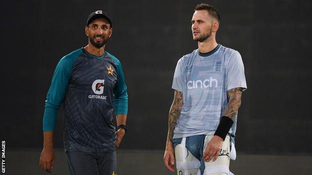 Pakistan batter Shan Masood (left) talks to England batter Alex Hales (right)