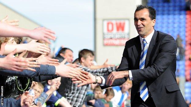 Roberto Martinez celebrates avoiding Premier League relegation with the Wigan fans in 2012