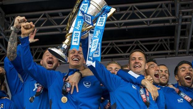 Portsmouth players lift the League Two trophy at a civic reception in Southsea