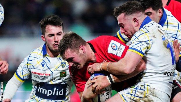 Clermont Auvergne's JJ Hanrahan attempts to halt Ulster's Marcus Rea at Stade Marcel-Michelin last weekend