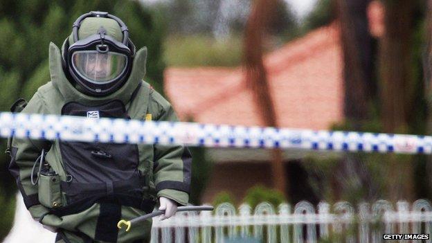 A bomb disposal officer walks down Wilson Street in Green Valley November 8, 2005 in Sydney, Australia.