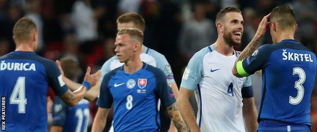 England's Jordan Henderson celebrates his win as he confronts Slovakia's Martin Skrtel