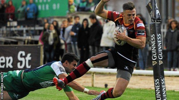 Dragons' Nick Scott is pushed into touch by Tiernan O'Halloran of Connacht