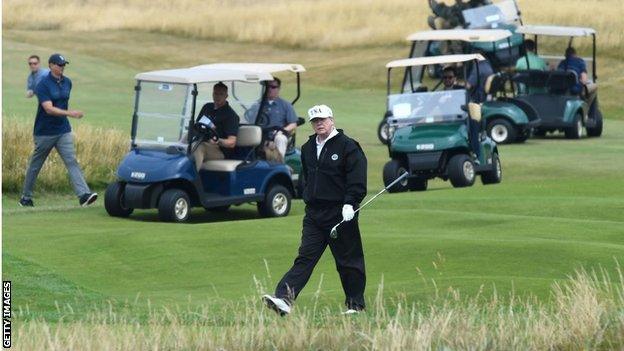 Donald Trump plays a round of golf in Scotland in 2018