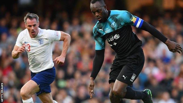 Jamie Carragher (left) had a tough time marking sprinter Usain Bolt