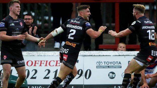 Tommy Makinson (centre) of St Helens celebrates his first try against Wakefield