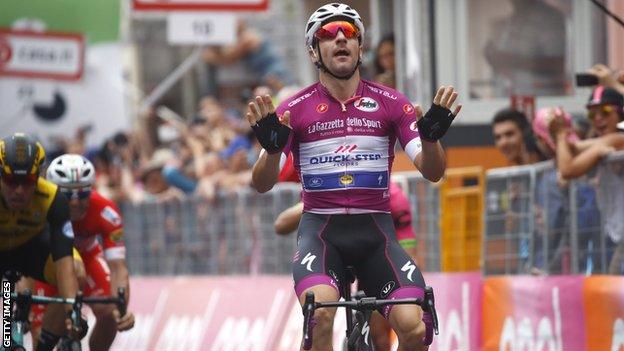 Elia Viviani celebrates victory after crossing the line on stage 13